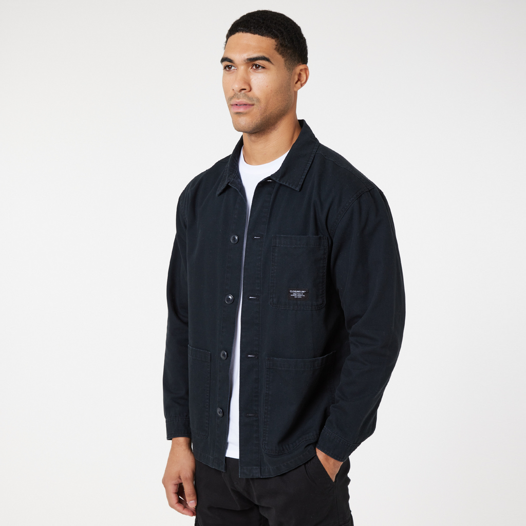 Black men's overshirt jacket with black buttons over a white top