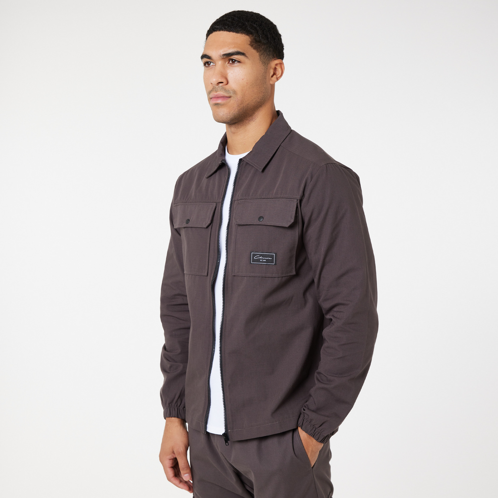 Men's zip up overshirt in washed brown paired with plain white top underneath