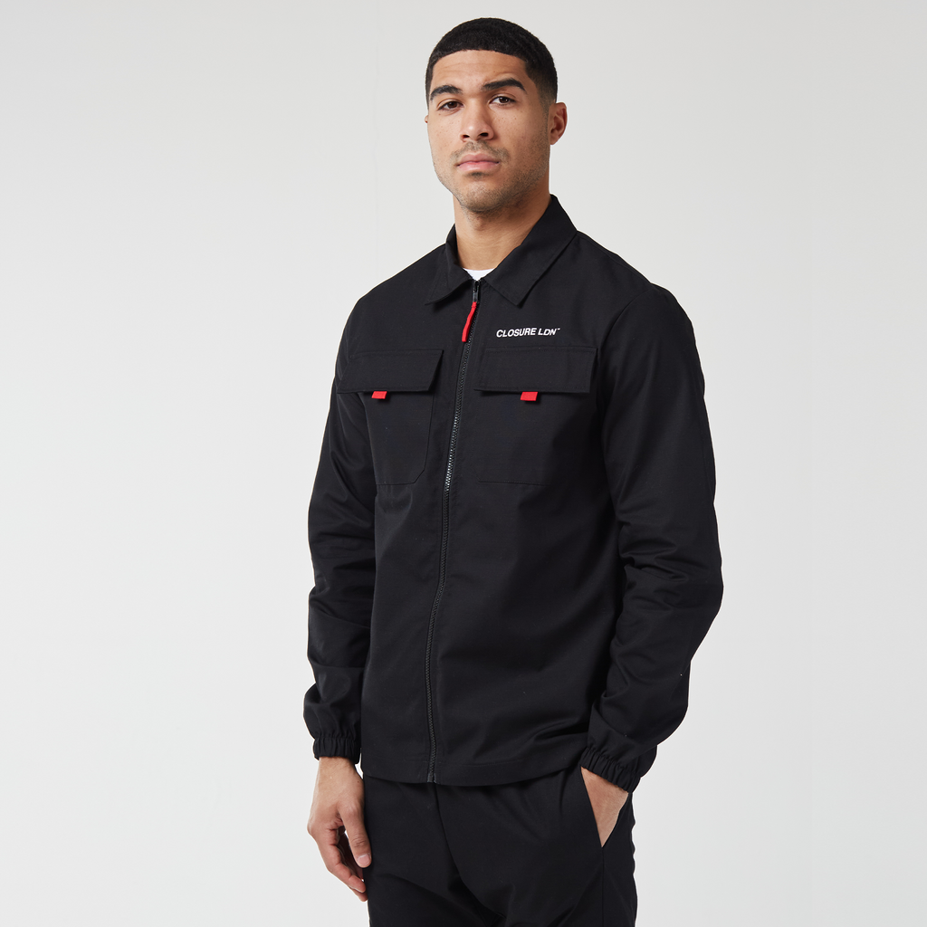 Black and red men's zip up overshirt on model