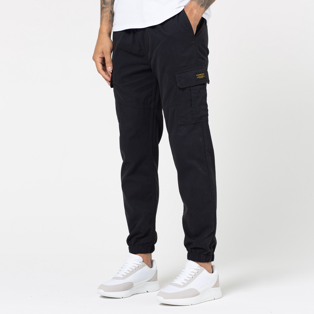 Classic men's utility cargo pants that are cuffed at the ankle and yellow logo on pocket