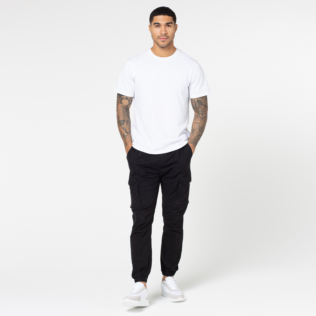 Men's utility trousers in black style with white and grey shoes and short sleeved white tee