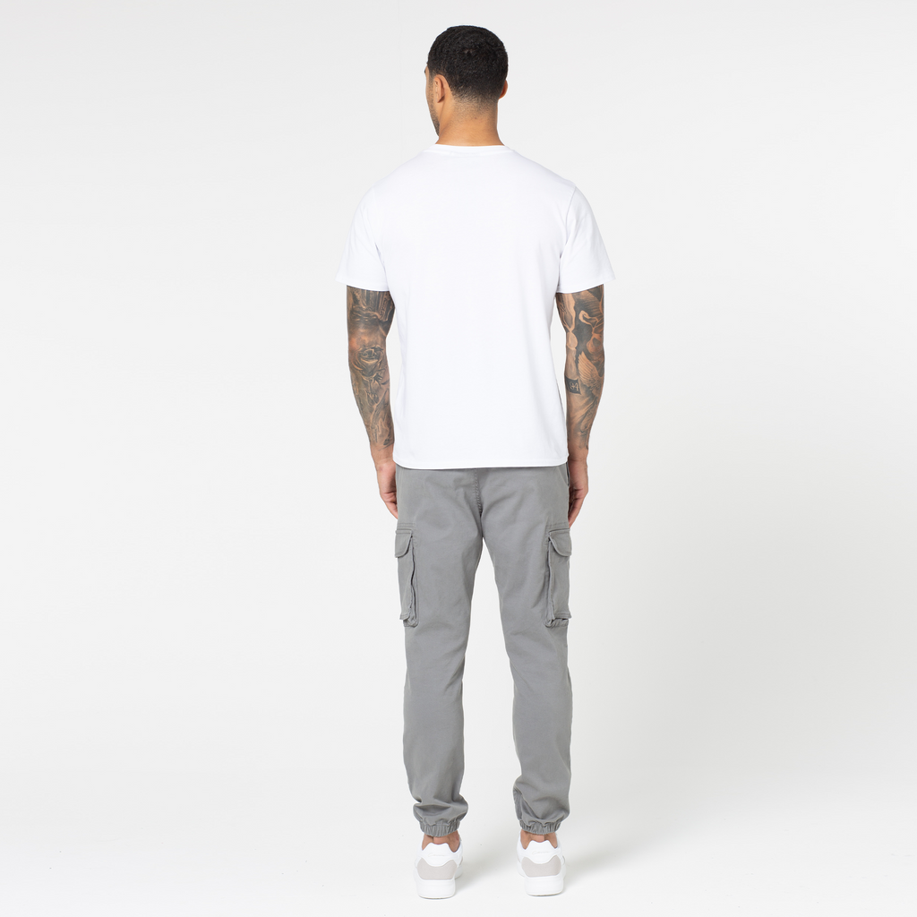 View of models back wearing plain white t-shirt with grey classic cargo pants