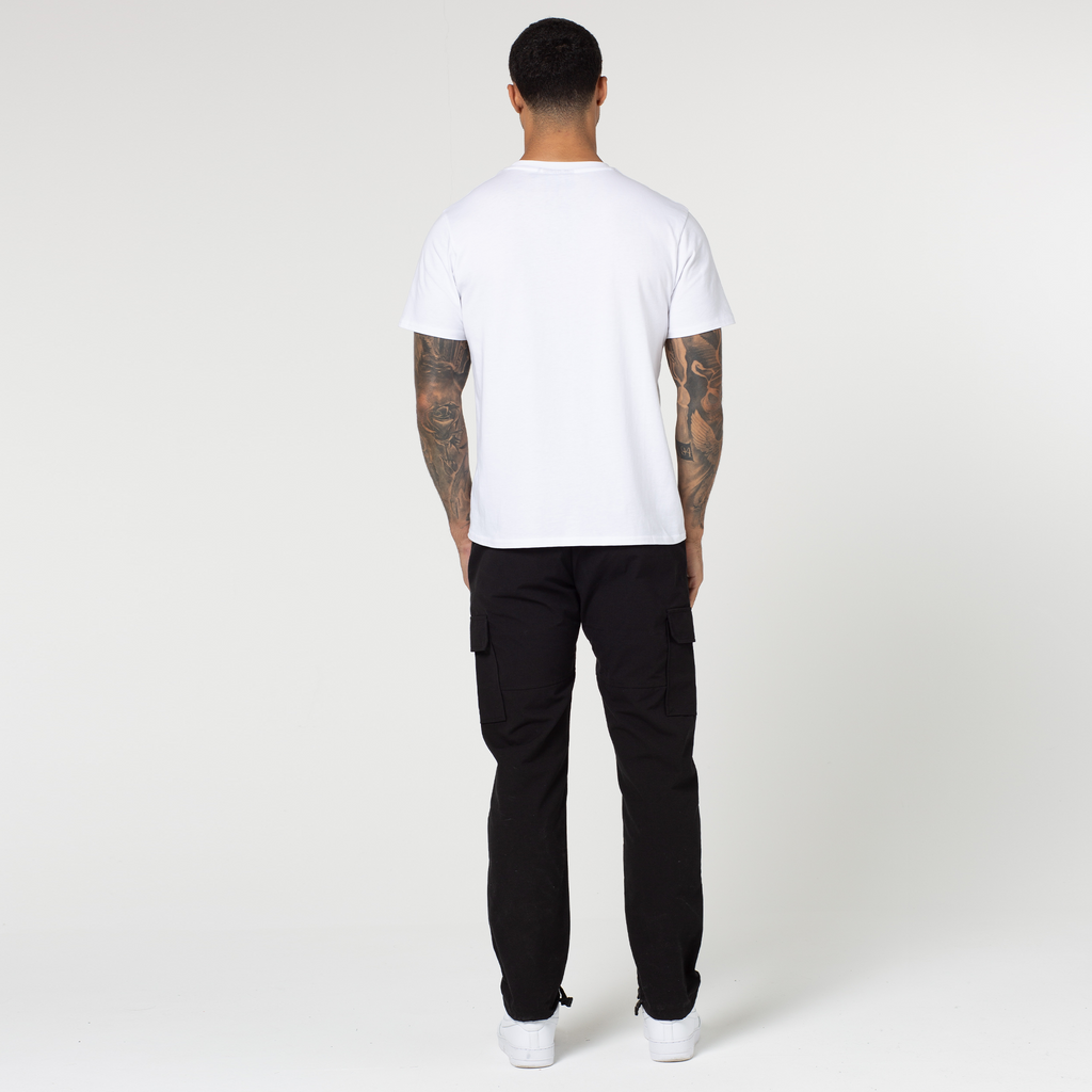 Back profile view of men's cargo trousers with plain white tee and trainers