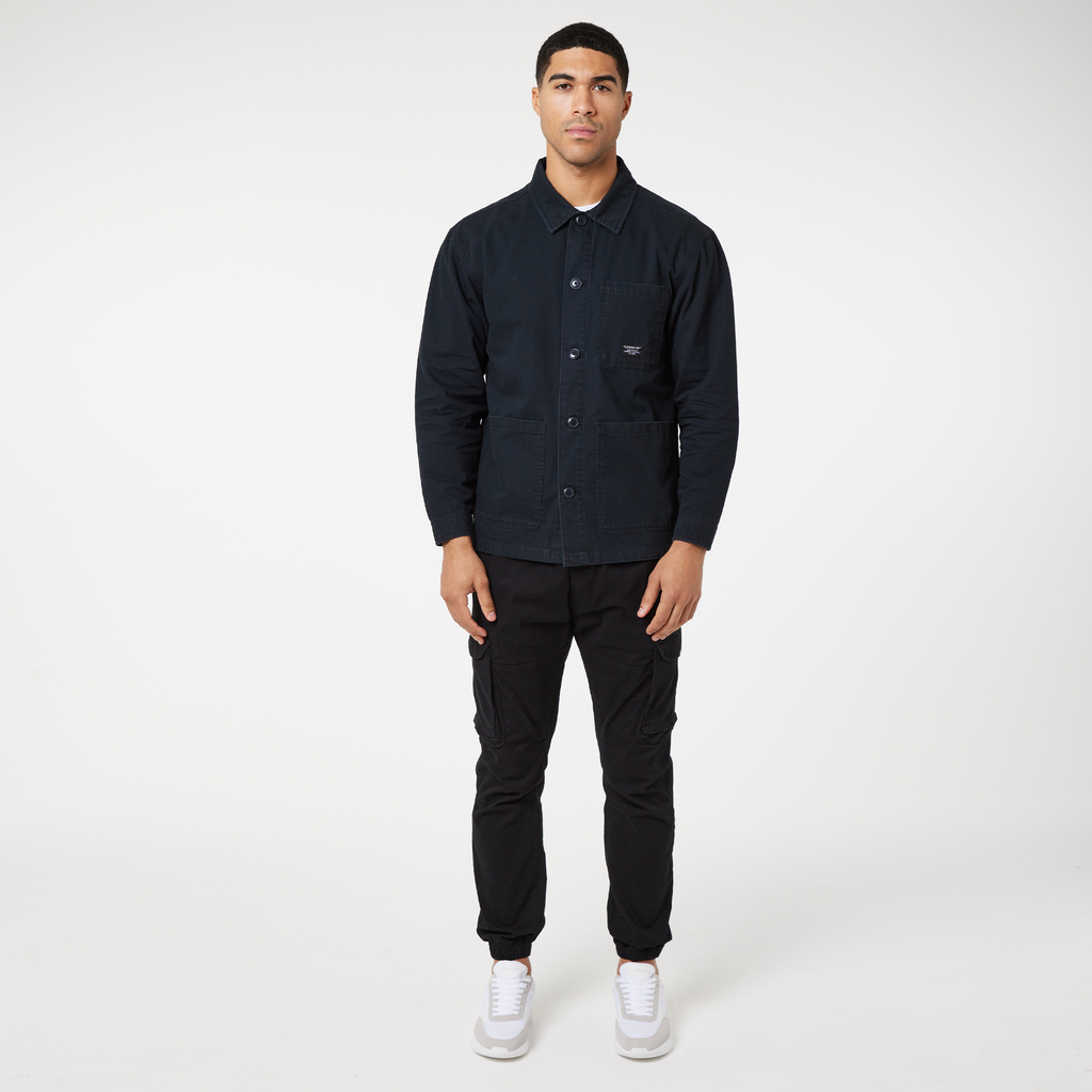 Buttoned up men's overshirt jacket paired with black cargo trousers