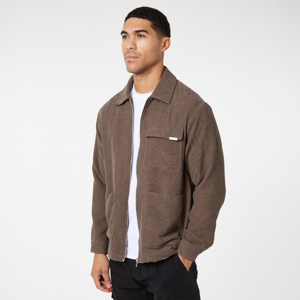 Model wearing brown corduroy overshirt with white top underneath
