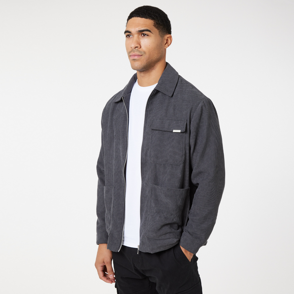 Model wearing men's corduroy overshirt unzipped with white top