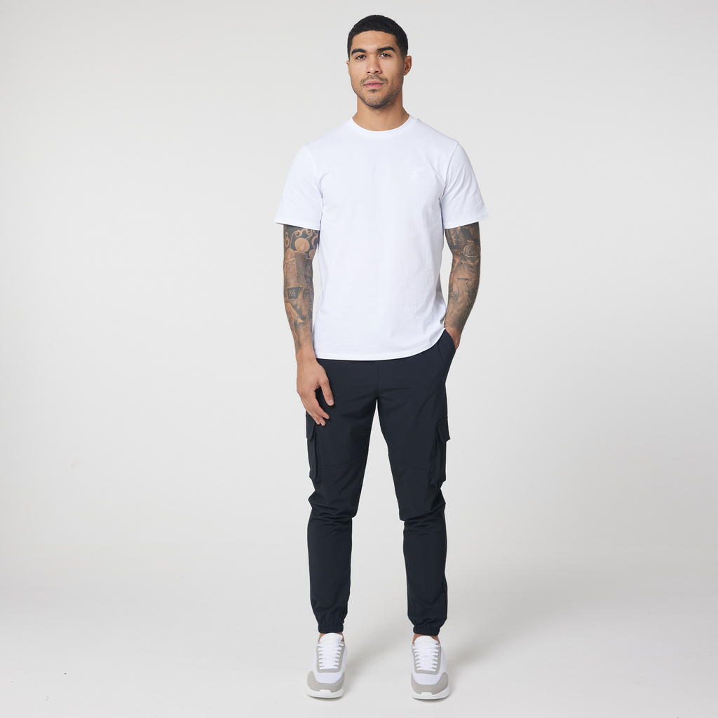Tech cargo pants in black styled with plain white top and white trainers