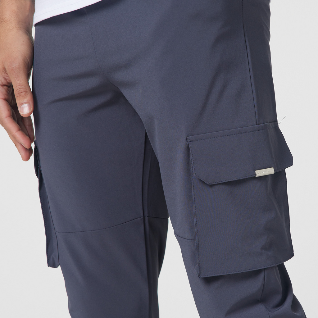 Close up of utility cargo pants pockets showing small tag on the pocket