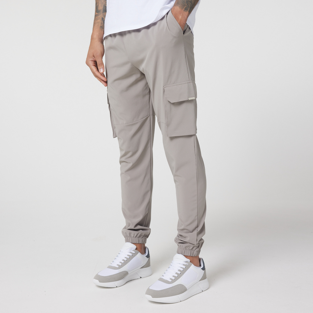 men's cargo pants in stone matched with white casual trainers