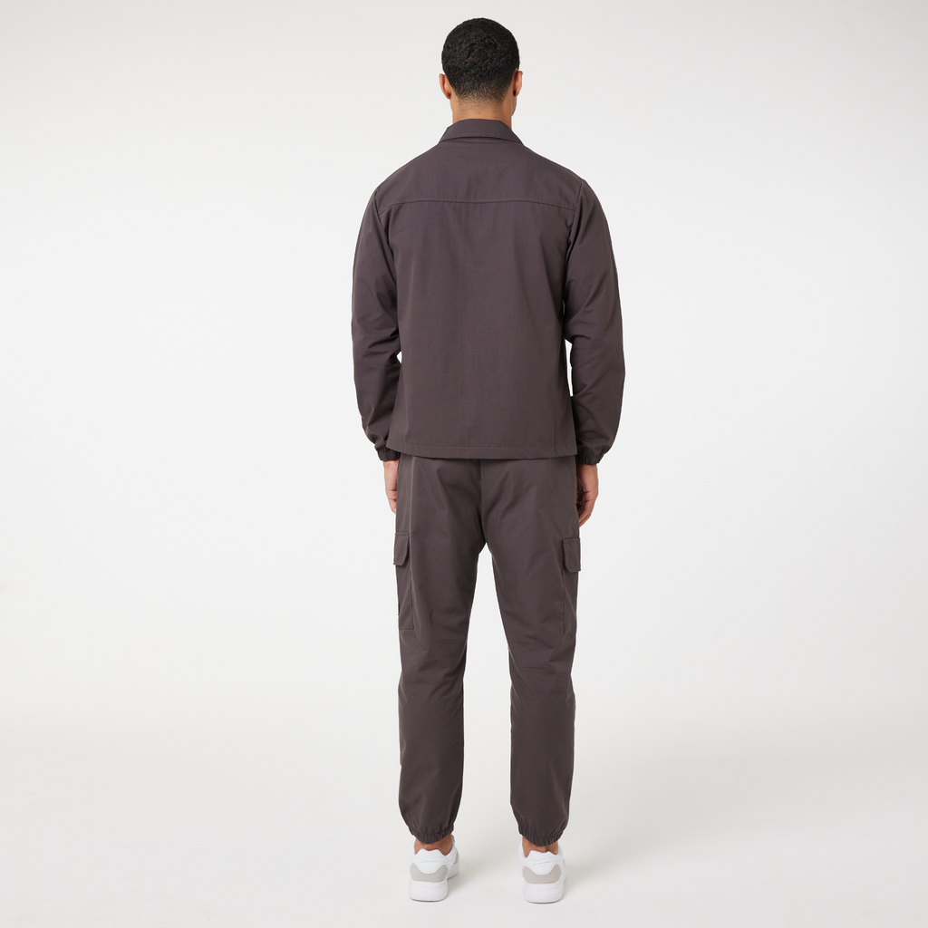 The back of washed brown matching set showing back of the cargo pants and back of overshirt jacket