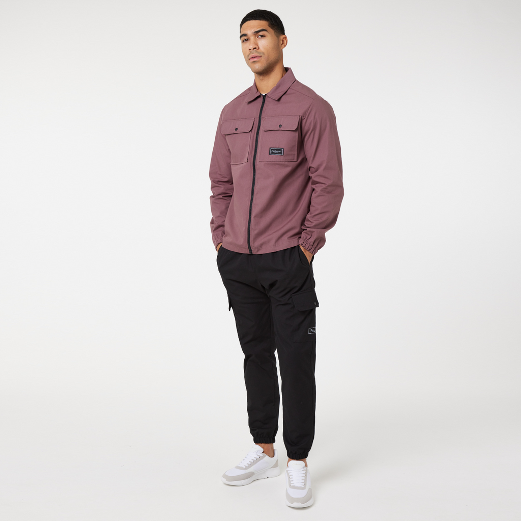 men's zip uo overshirt in burgundy paired with black trousers and trainers